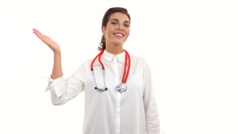 Young-female-doctor-waving-her-hand,-smiling-friendly,-crossing-arms-and-looking-at-camera.-Portrait-of-young-medical-professional-with-stethoscope-and-lab-coat-isolated-on-white-background