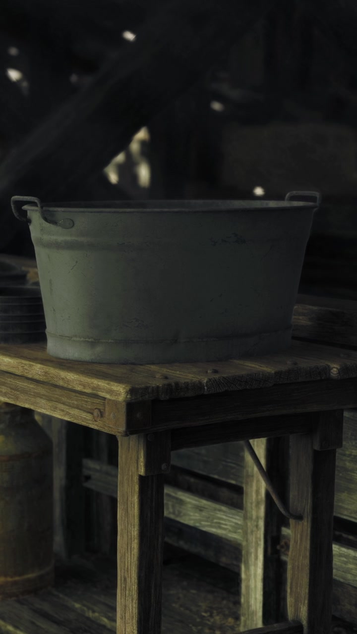 Metal tub sits on wooden table in dimly lit barn during daytime