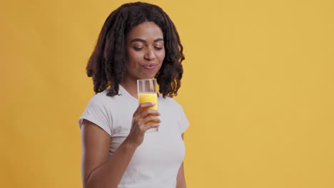 woman drinking orange juice