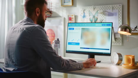 man working on a computer at home