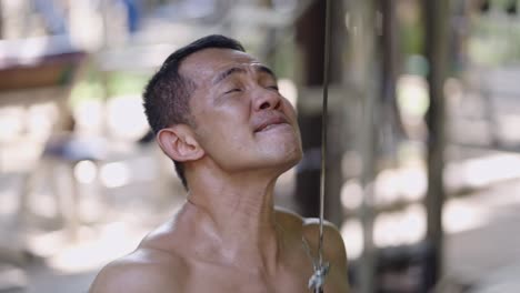 man exercising intensely at an outdoor gym