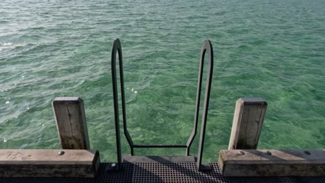 ladder on pier with ocean view