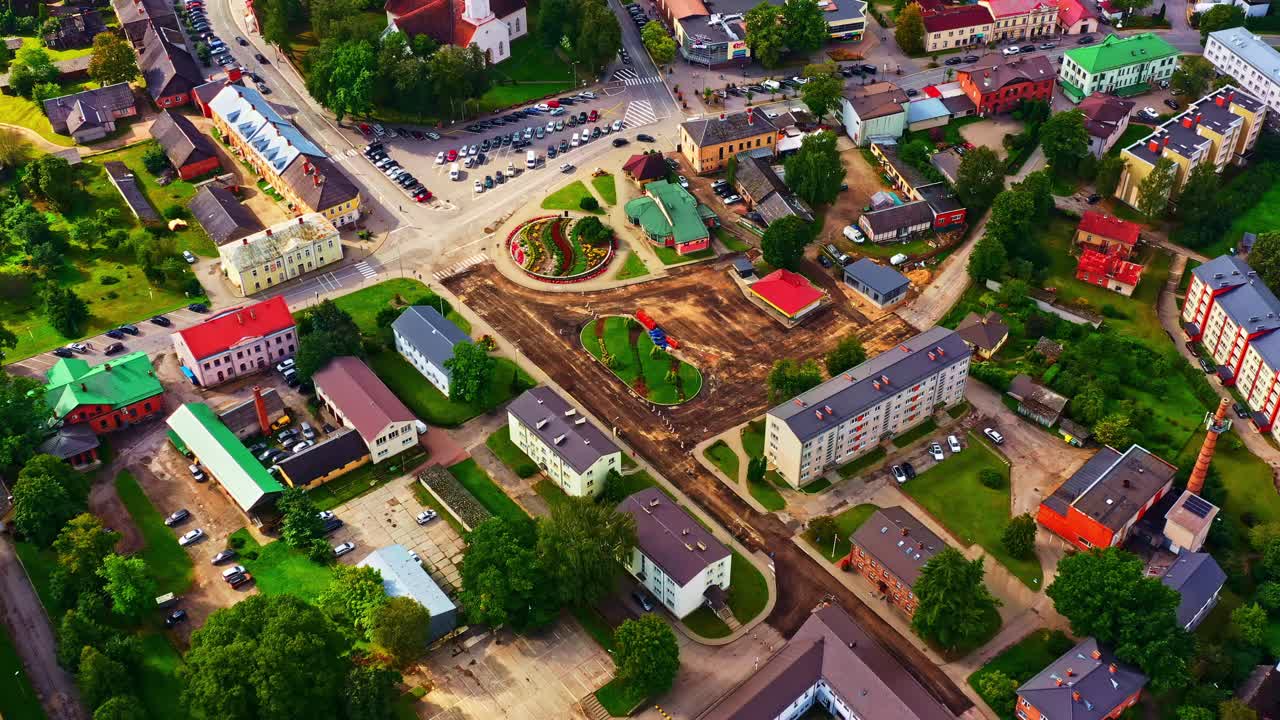 City center reconstruction with church, streets, and bright rooftops in evening sunlight