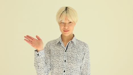 young woman with blonde hair waving hello