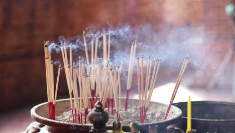 time-lapse of incense sticks burning and smoking