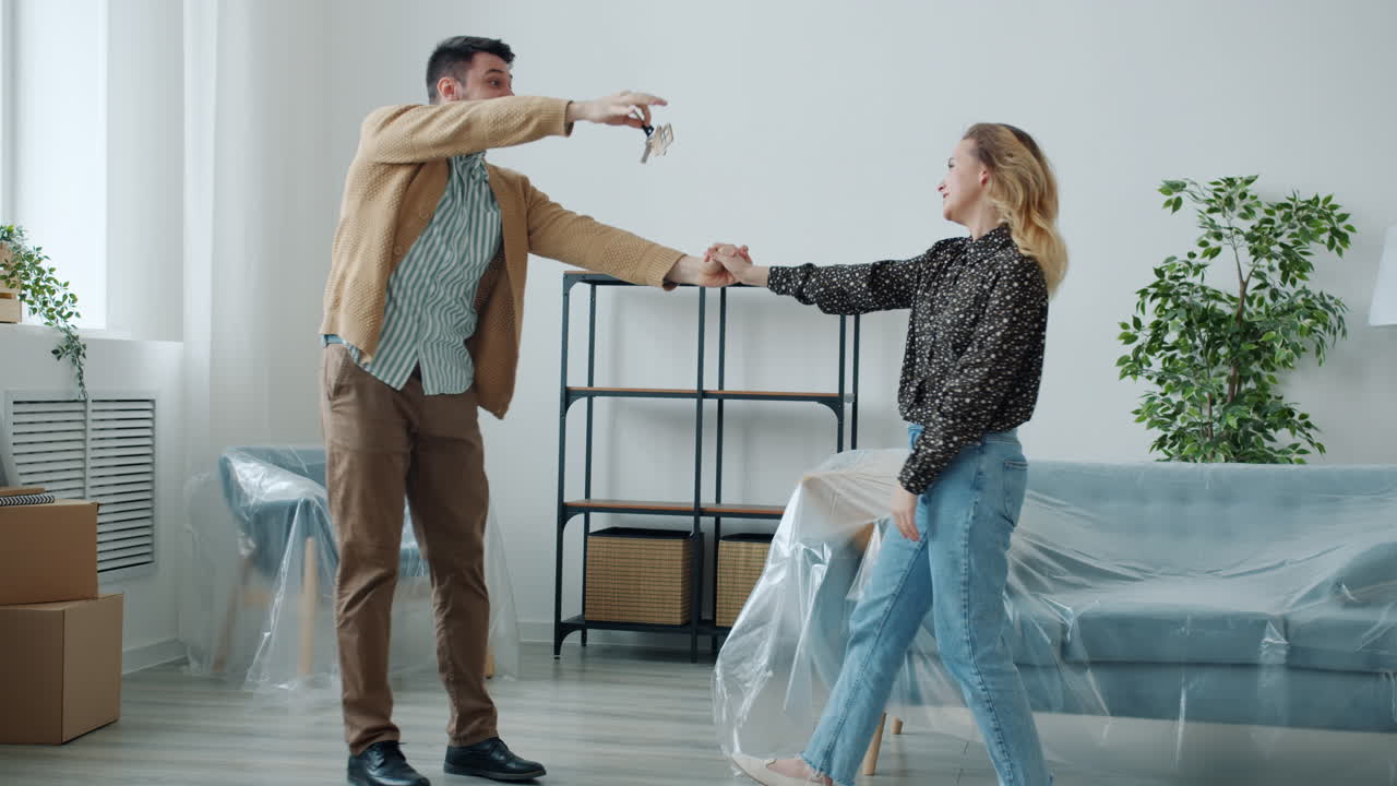 Happy Couple Dancing in Their New Home