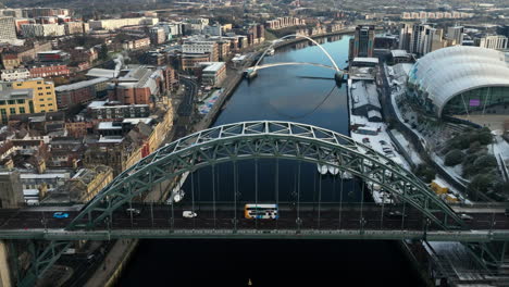 beautiful winterry slow pull back over newcastle tyne bridge to reveal millenium bridge in the background