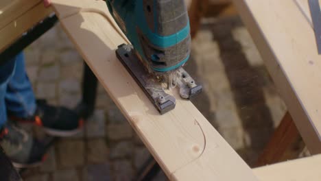 close up of cutting out a pattern of wood with a jigsaw