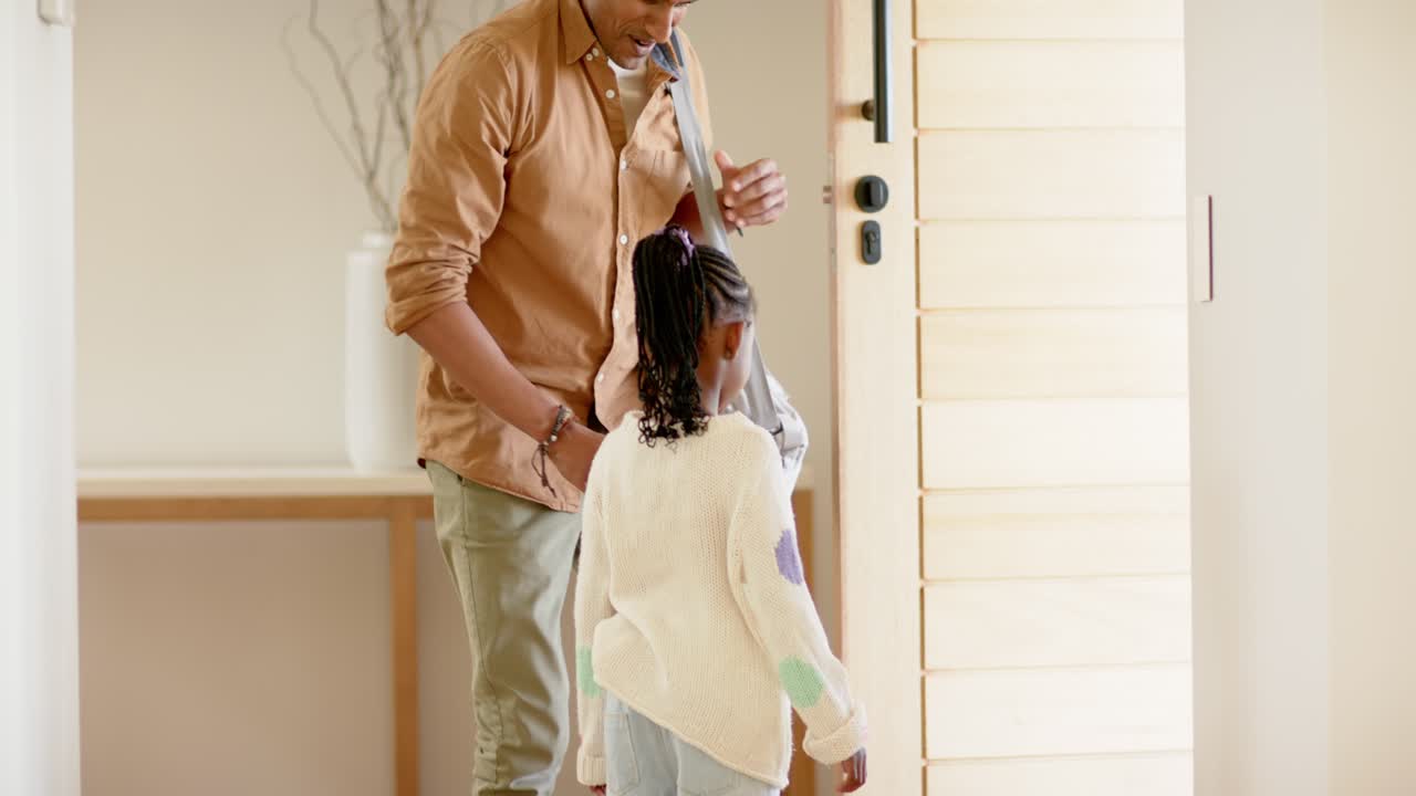 Father arriving, greeting African American daughter, opening door guiding her outside
