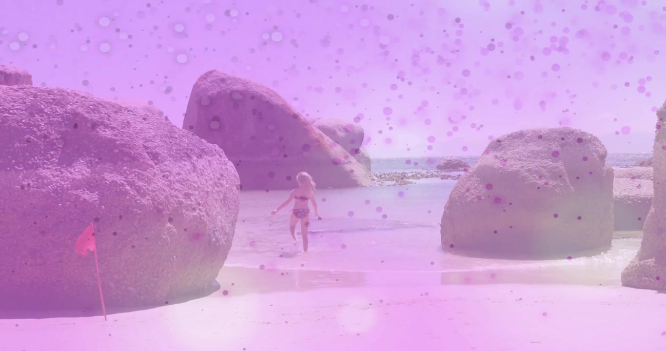 Girl walking to beach inlet, causing pink overlay speckles, heading to water to play for marketing