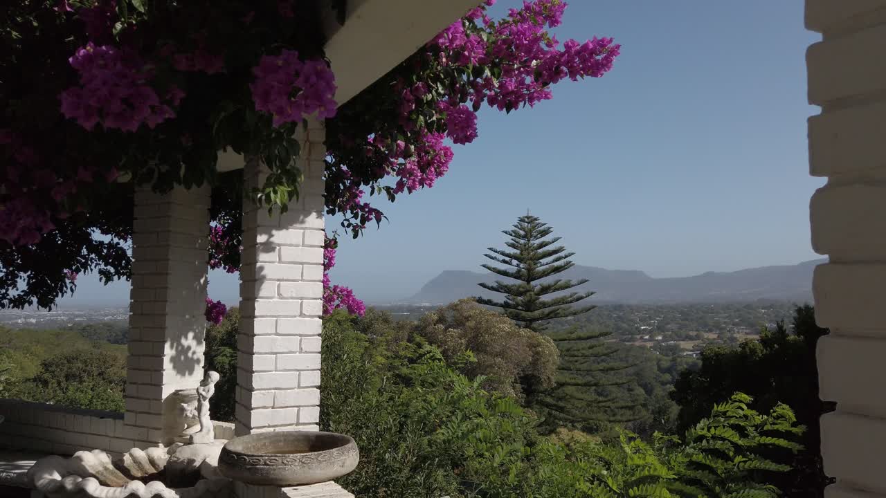 Vibrant bougainvillea on a balcony with a scenic mountain view