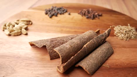 assorted spices on a wooden cutting board