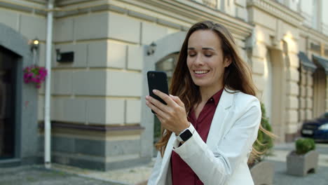 successful business woman having video call outdoors