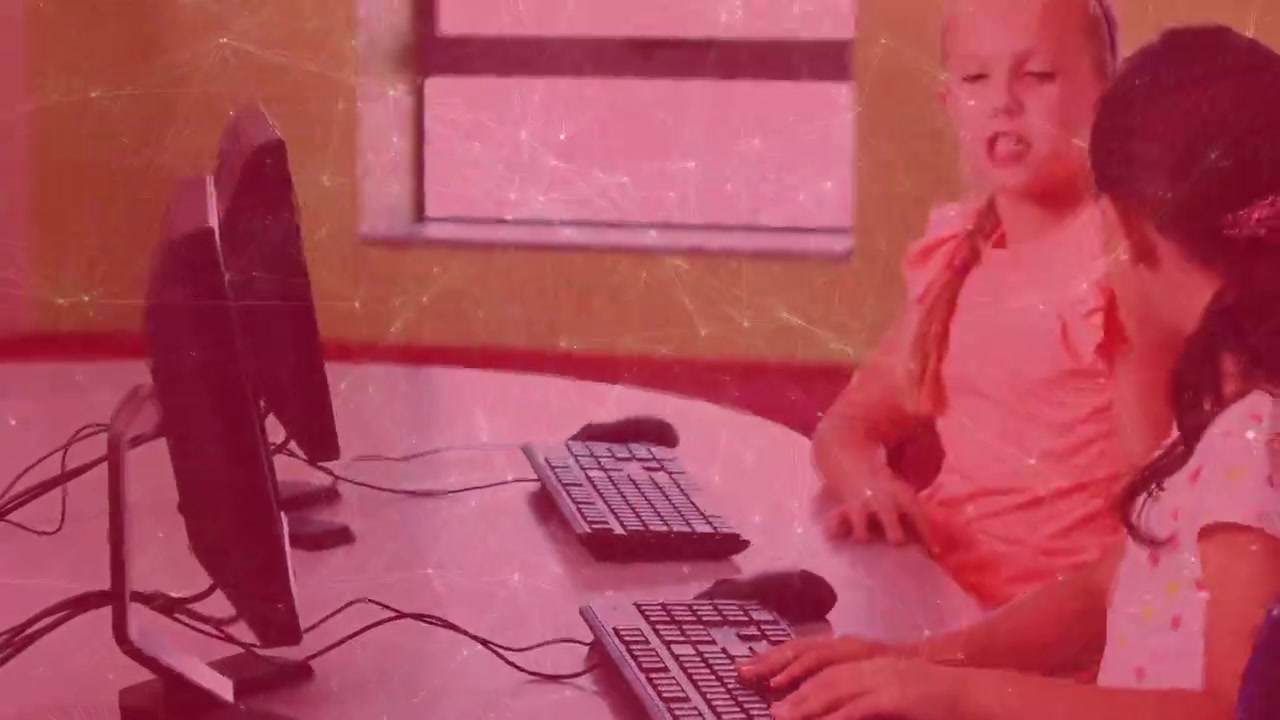 Young Girls Learning and Typing on Computers in a Classroom with Digital Network Overlay