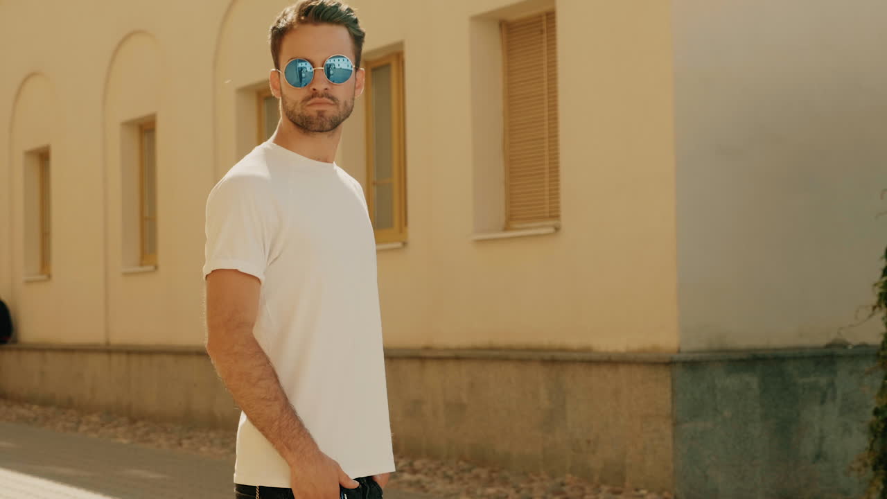 hombre elegante con camiseta blanca y gafas de sol