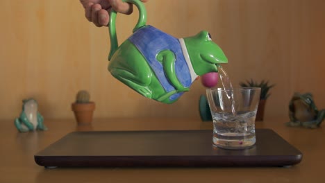 glass on a tray being filled up with water pouring from a carafe