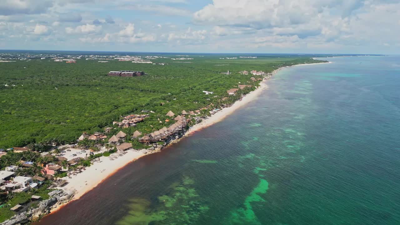 Aerial view of Tulum's beach coast and lush jungle, sunny day