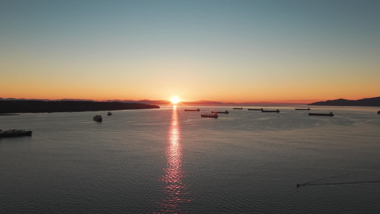 Aerial wide dolly shot of Burrard Inlet during sunset on a perfect evening in Vancouver, British Columbia, Canada. 4K