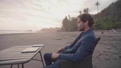 freelancer working on beach at sunset