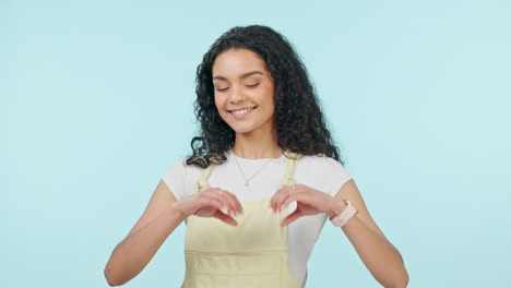 Heart-hands,-love-and-a-young-woman-in-studio