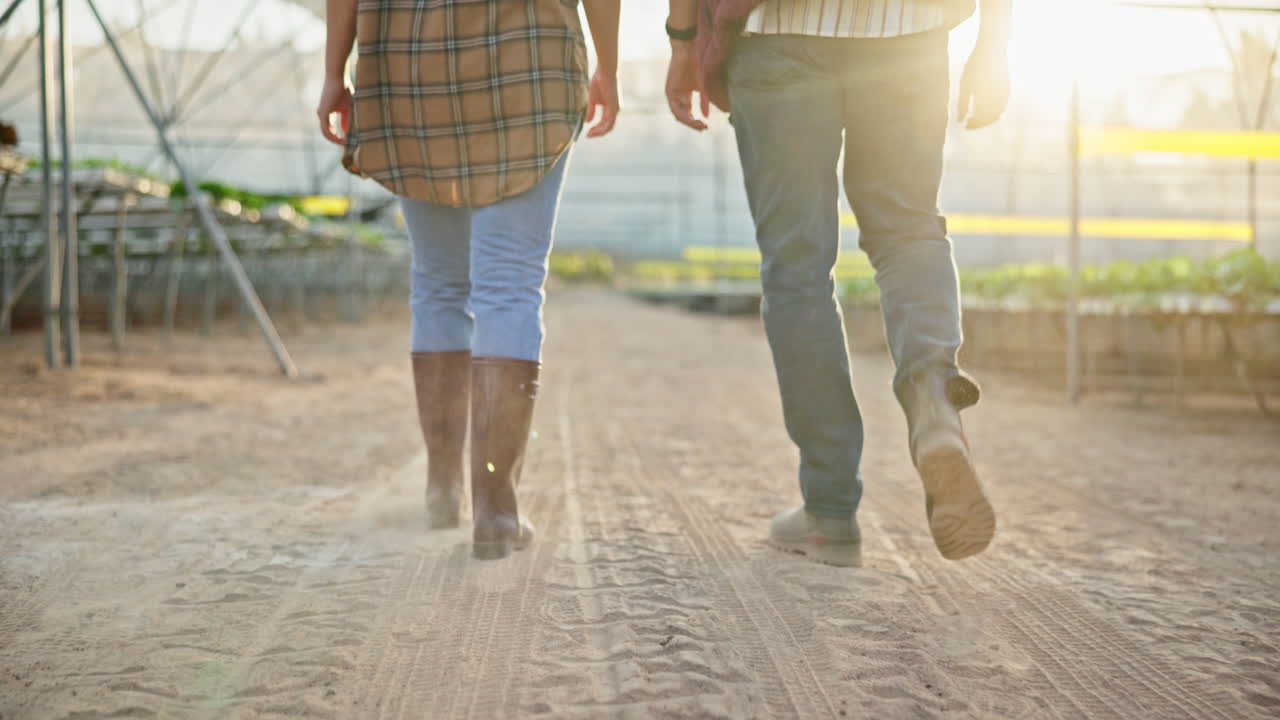 Farmers walking through a greenhouse