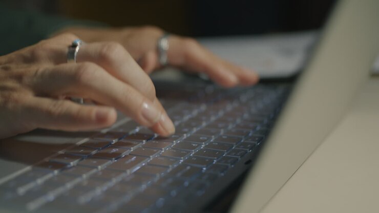 Woman Typing on a Laptop