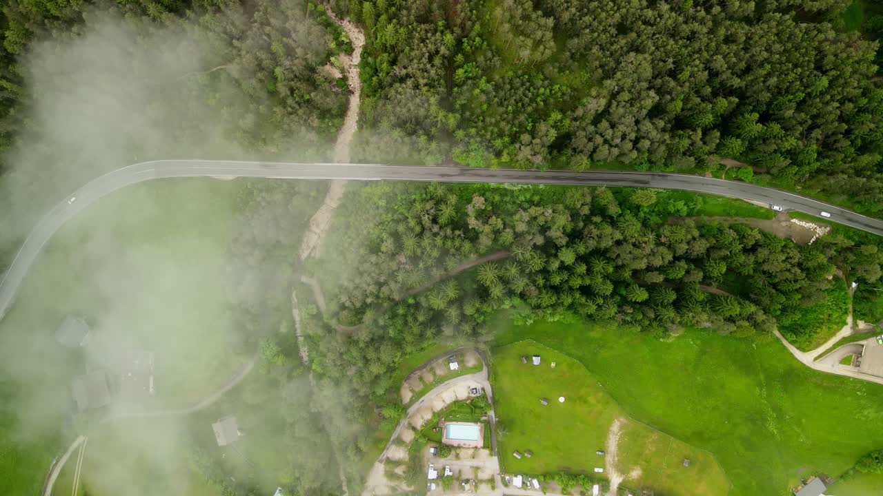 Eagle eye view of Seiser Alm Roadway through forest with cloud cover