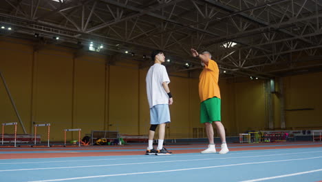 senior and young man talking indoors