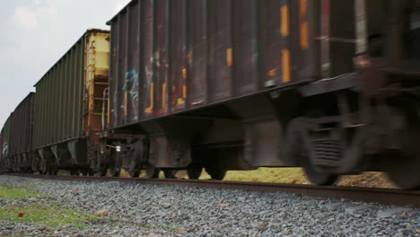 still frontal close up of locomotives towing train wagons during the day on a railroad