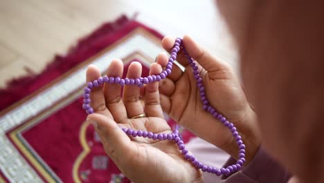 woman praying with prayer beads