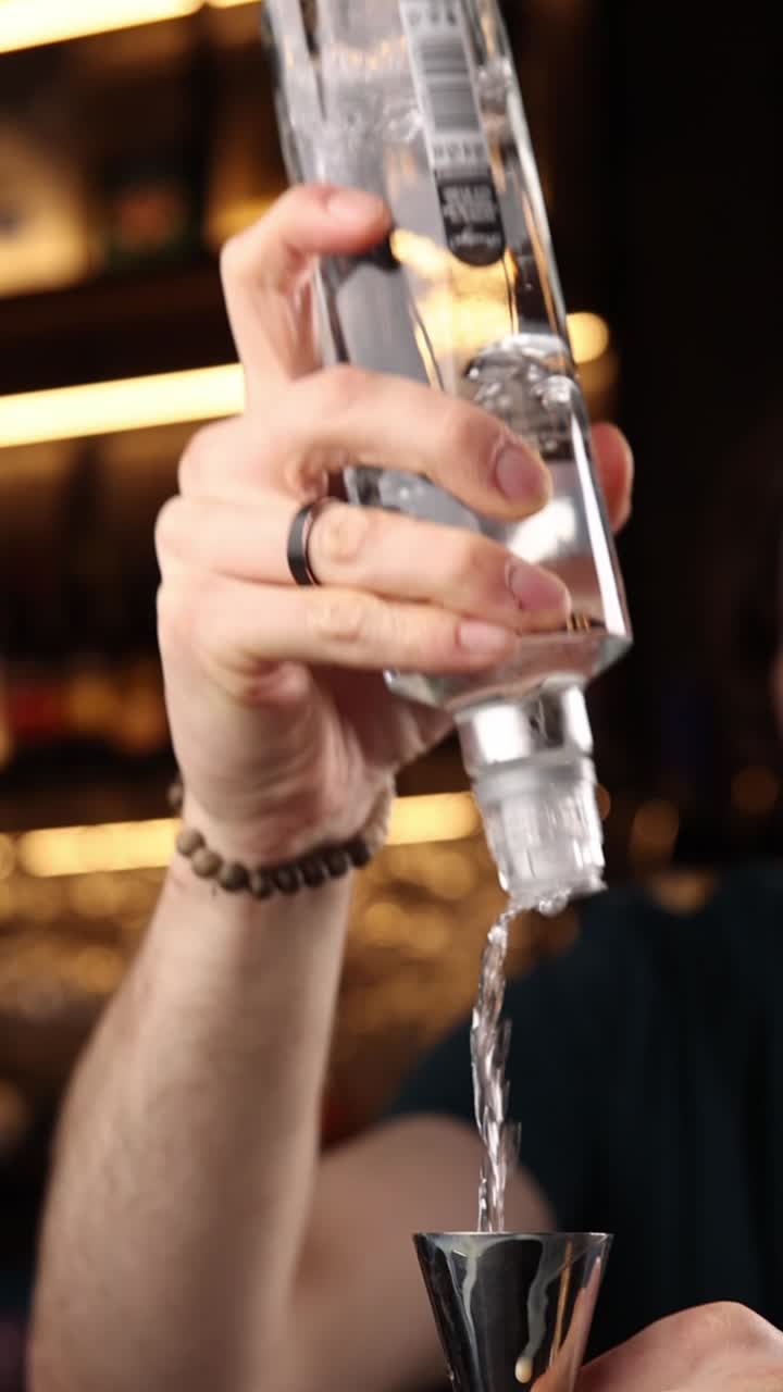 Pouring alcohol into a jigger