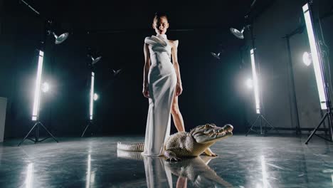 woman in white dress with crocodile