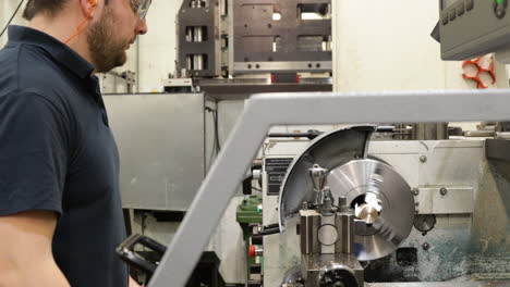 worker operating a lathe in a metal fabrication plant