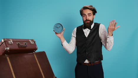 Classy-bellhop-poses-with-wall-clock