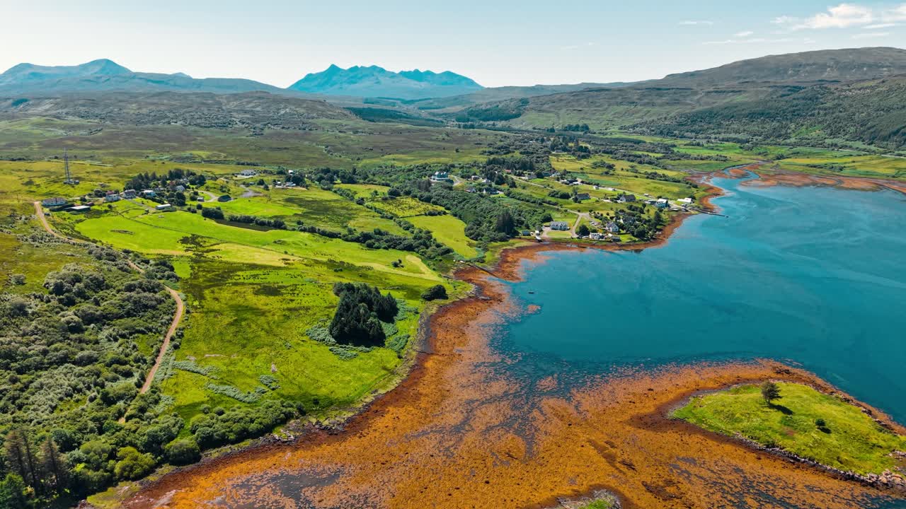 Aerial View of Scottish Landscape with Mountains, Coast, and Village