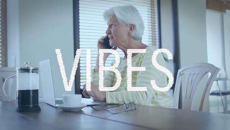 animation of vibes text in white over anxious caucasian senior woman making phone call, using laptop