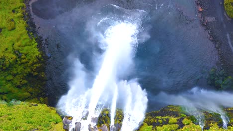 top-down shot overhead the seljalandsfoss waterfall flowing and spraying