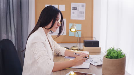 pensive focused woman uses calculator at work in office