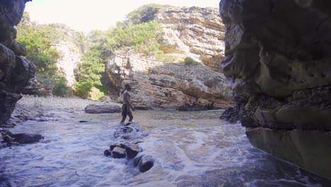 the young man is walking in the sea canyon.