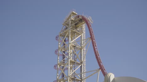 gorgeous footage of a roller coaster climbing a steep lift hill, and then plunging down towards earth