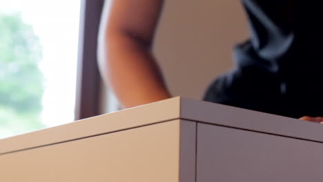 young boy finishes up shelf building, putting together last piece