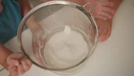 children sifting flour