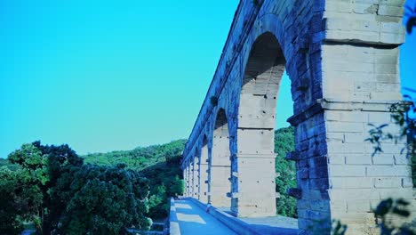 pont du gard in france stone arches with nature in the foreground