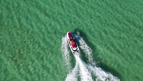 Water-scooter-moving-fast-in-shallow-tropical-sea-water,-birds-eye-aerial-view