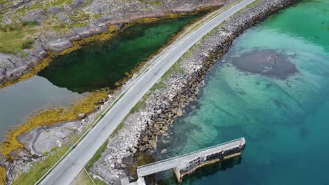 car driving on the road between to waters towards hemmingsvaer norway