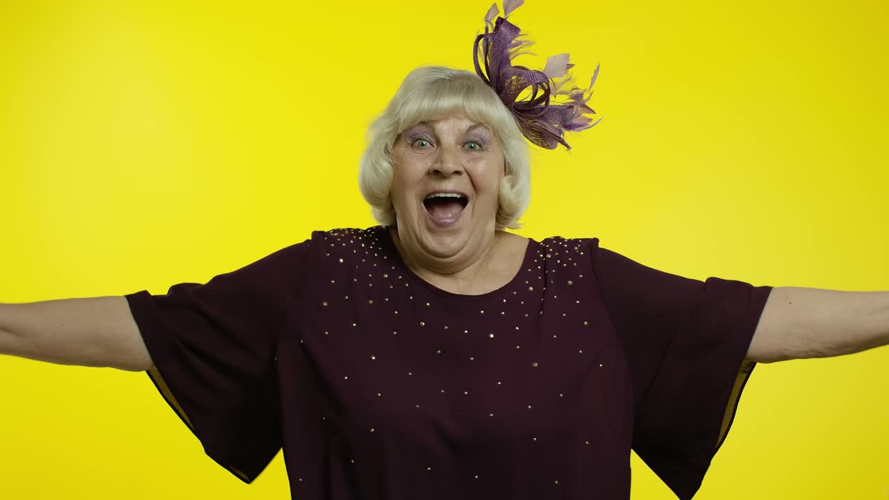 Kind-hearted senior woman showing beckoning gesture, embracing. Elderly stylish grandma wants to hug