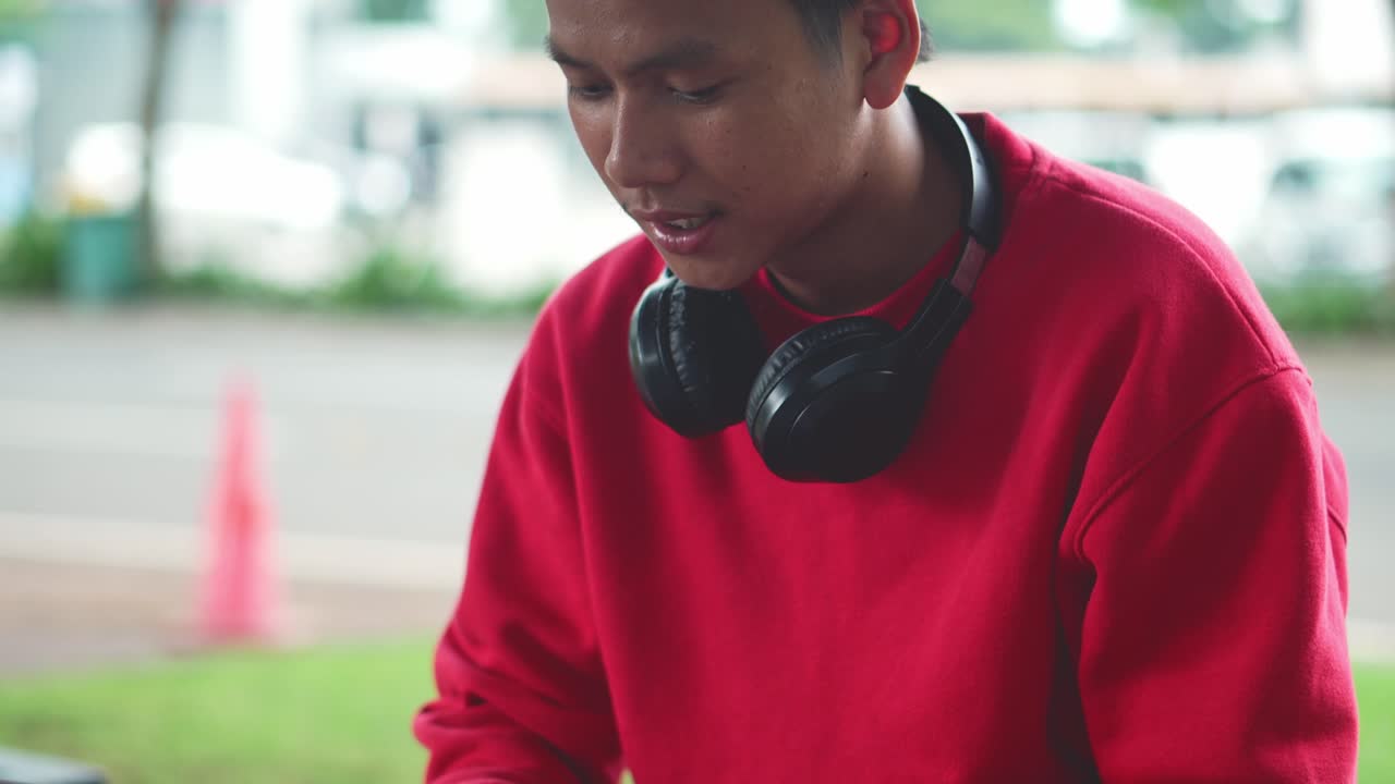 Busy Young Asian Man Freelancer Working On Laptop At Park And Clenched Fist Celebrating Successful Project