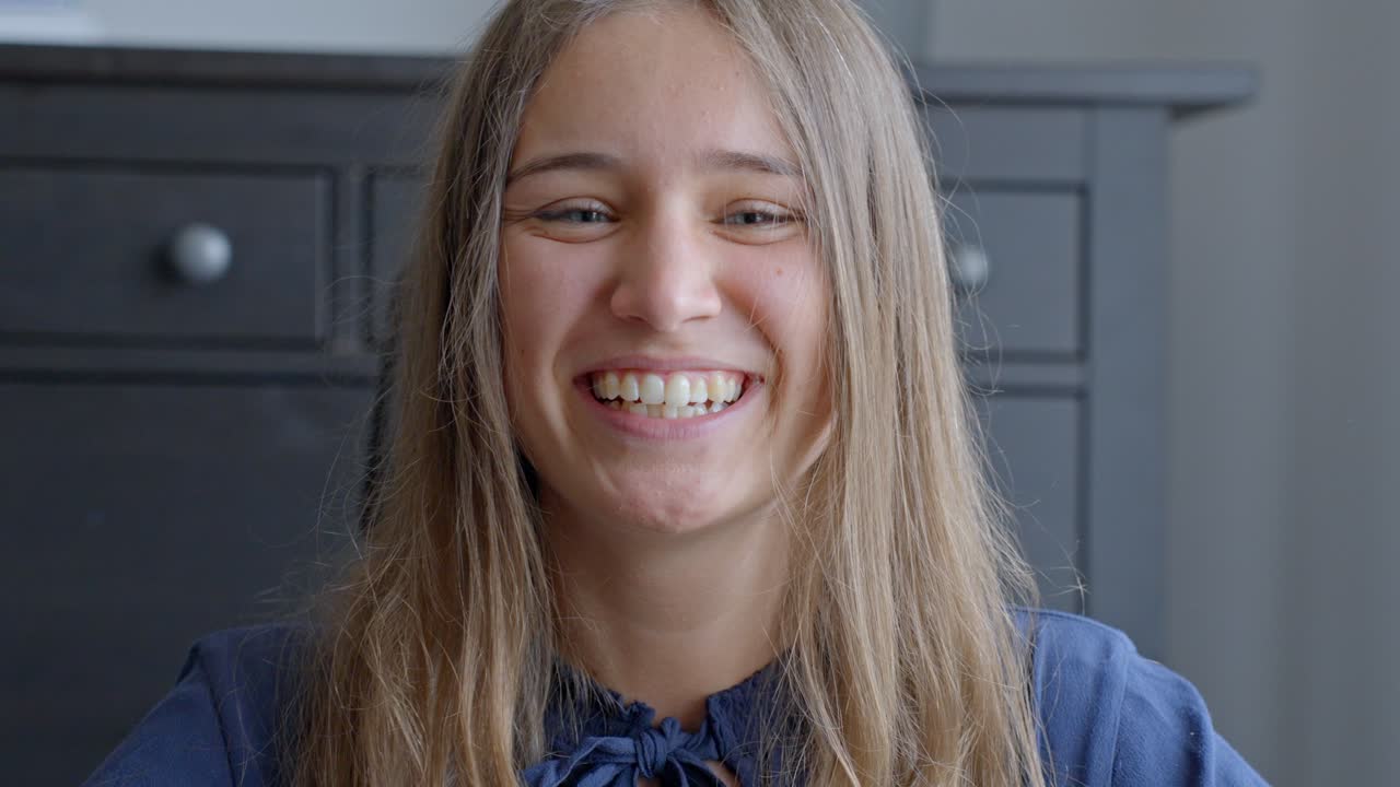 Happy cheerful woman smiling into camera, portrait close up view