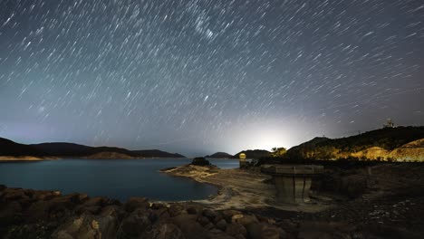 epic star lapse over high island west dam sai kung hong kong with burst of light on horizon