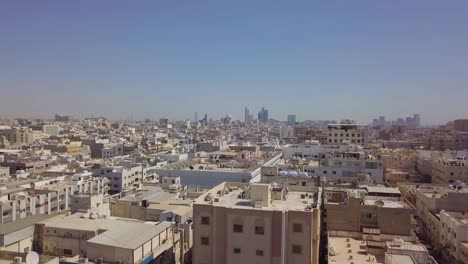 aerial footage of vertical reveal of khobar city skyline with towers in the background and